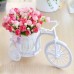 White artificial plastic bicycle with colourful flowers