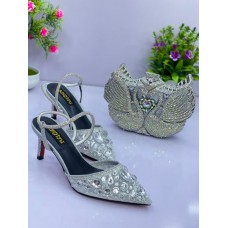 Women shoe silver colour with a clutch purse